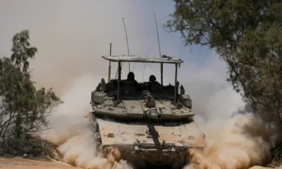 Kulu Media - A tank on a road in Gaza with too much dust floting around.